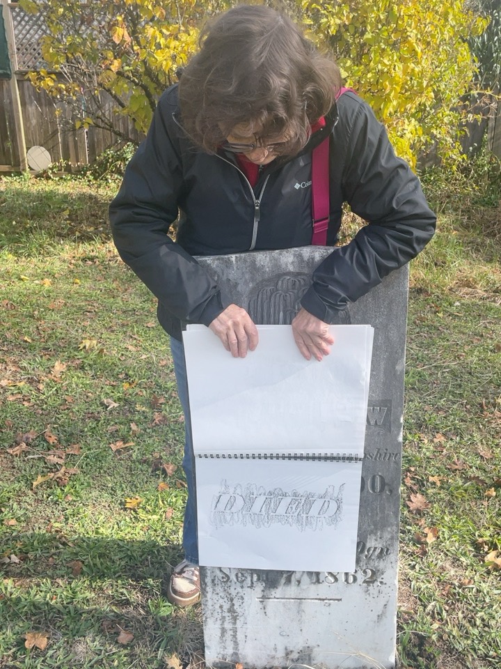 At Mulkey Cemetery, the other charter member holds a sketchbook rubbing against Hilyard Shaw's gravestone.